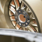 Close up Photo of gold Apex ML-10RT Forged Touring Line wheel Side-Milled Spokes